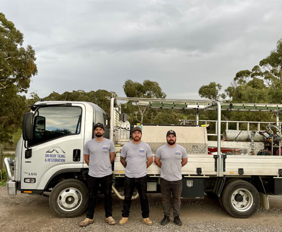 A photo of the DN Roofing - roof restoration team standing in front of the work truck.