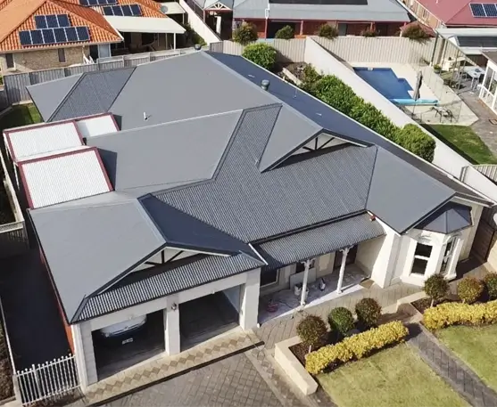 DN Roofing & Restoration homepage image of a re-roofing project, an arial photo of large family home with a brand new dark grey Colorbond roof.